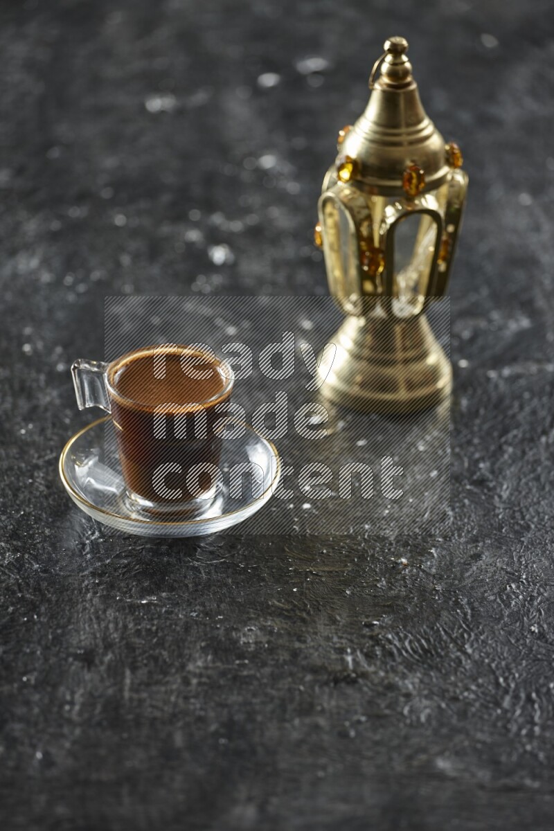 A golden lantern with different drinks, dates, nuts, prayer beads and quran on textured black background