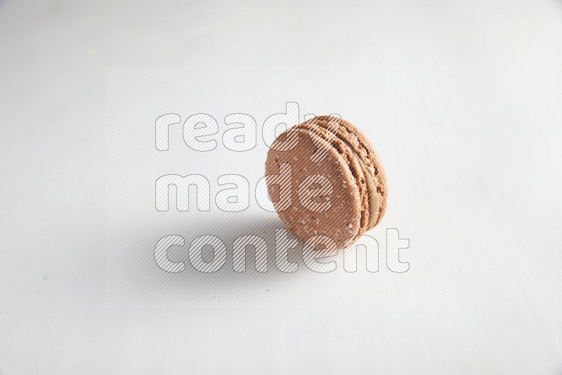 45º Shot of Brown Hazelnuts macaron on white background