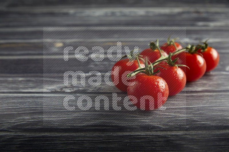 Red cherry tomato vein on a textured grey wooden background 45 degree