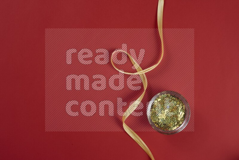 A yellow collection of sewing and tailoring tools arranged on a red background