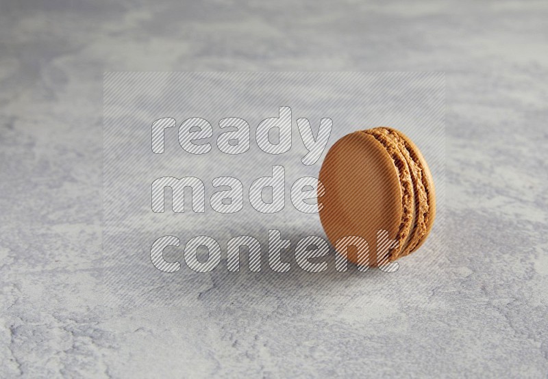 45º Shot of Brown Maple Taffy macaron on white  marble background