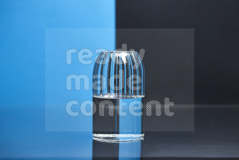 The image features a clear glassware filled with water, set against blue and black background