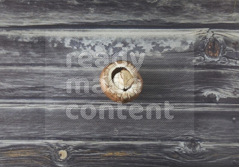 small fresh Cremini wood mushrooms topview on grey wooden textured background