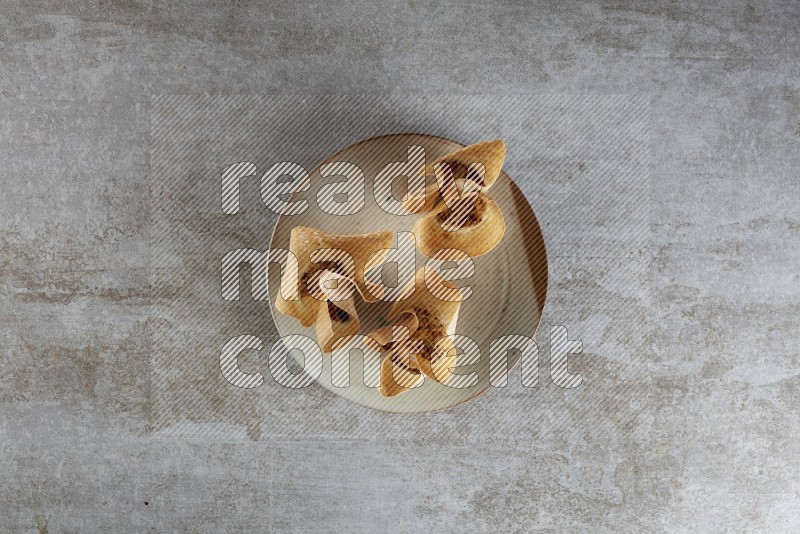 wonton cups with soy sauce ramkin on multi colored pottery on grey textured counter top