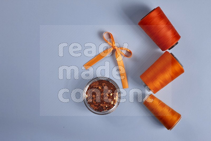 Orange sewing supplies on blue background