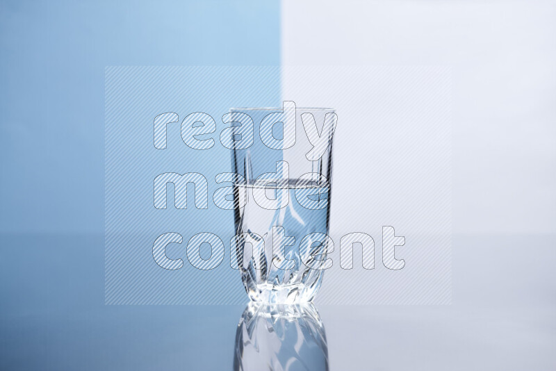 The image features a clear glassware filled with water, set against white and light blue background