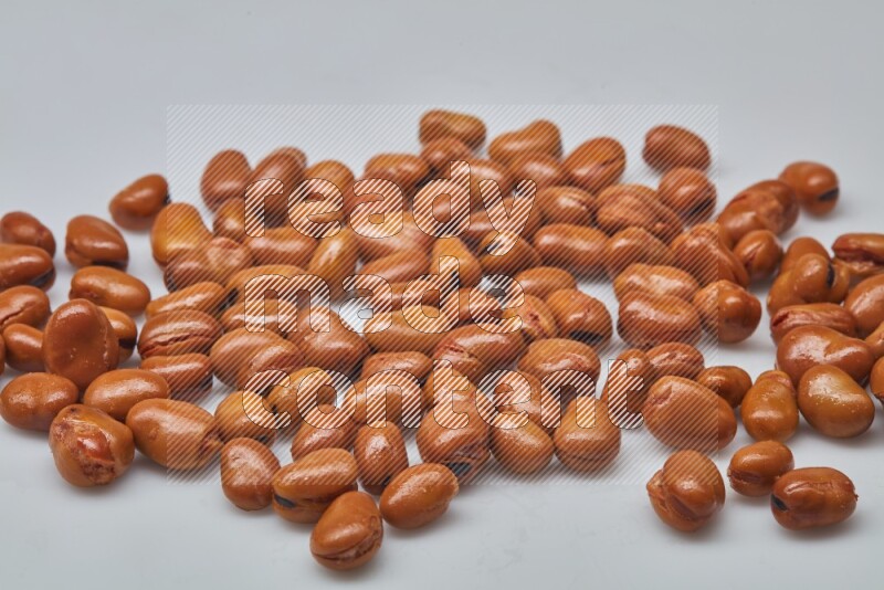 Close up shot of cooked fava beans (foul) on white background
