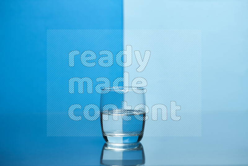 The image features a clear glassware filled with water, set against blue and light blue background