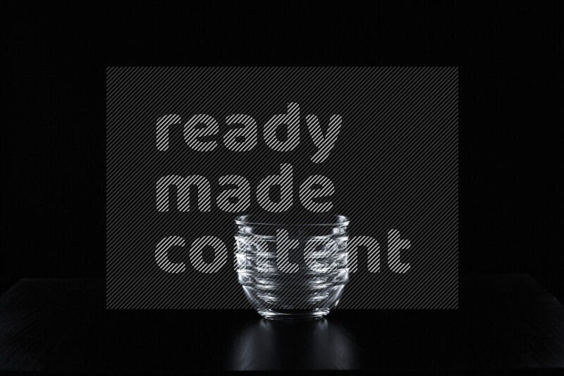 Glassware with rim light against black background