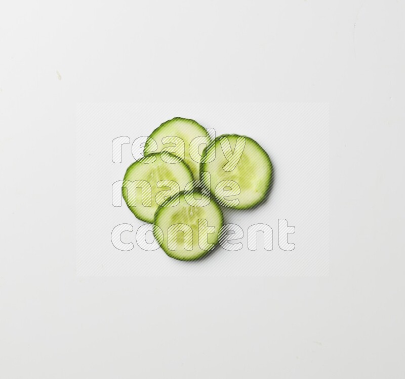 Multiple cucumber slices on white background