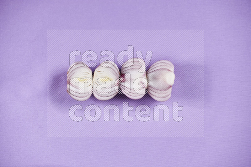 Halves red onions on a purple background