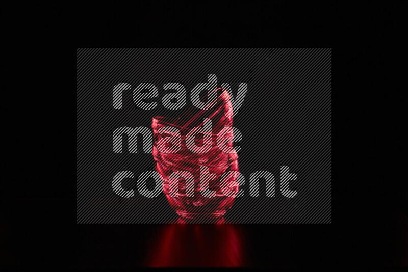 Glassware with rim light in red against black background