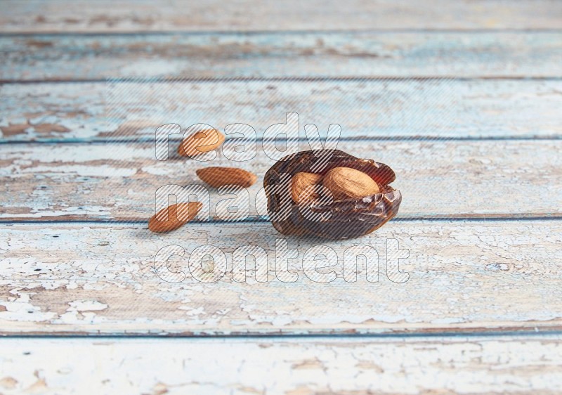 almond stuffed madjoul date on a light blue wooden background