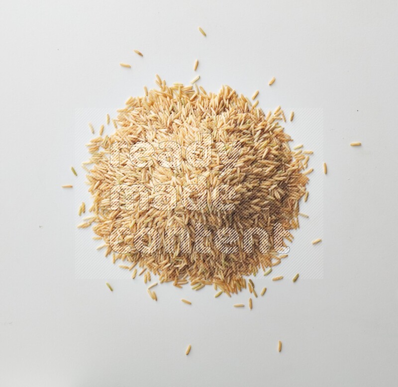 Top-view shot of long grain brown rice on white background