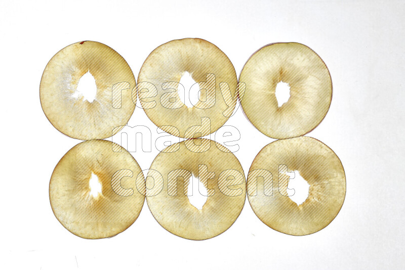 Peach slices on illuminated white background