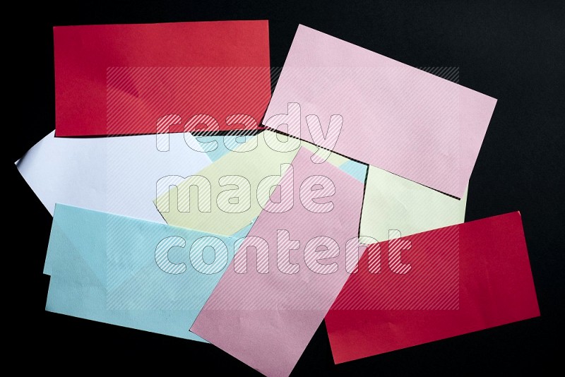 Multicolored paper sheet on black background