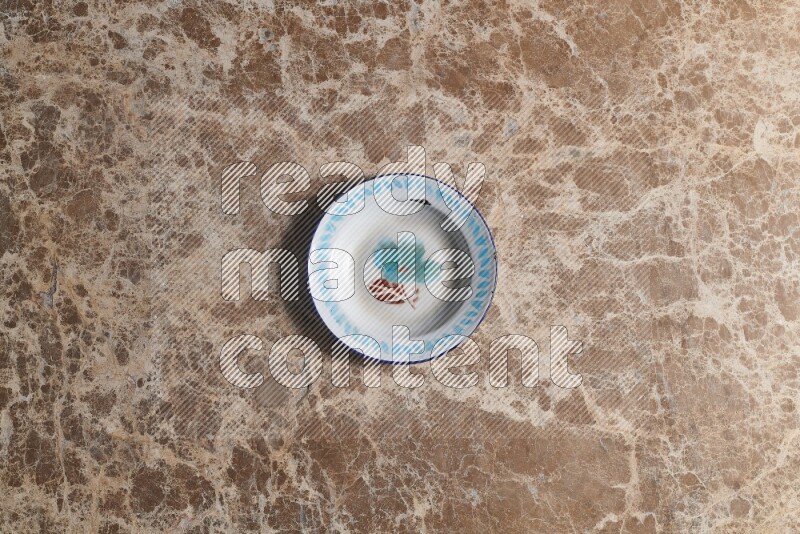 A vintage metal plate on beige marble background