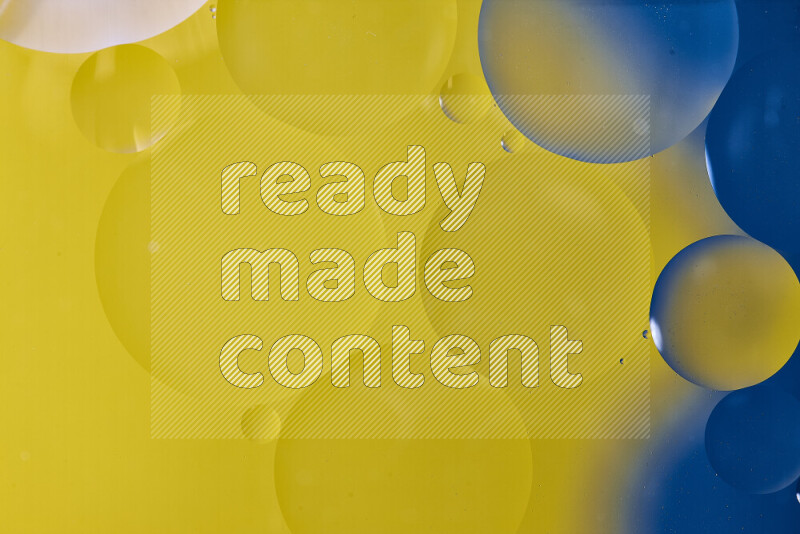 لقطات مقربة لفقاعات من الزيت على سطح الماء باللون الأزرق والأصفر