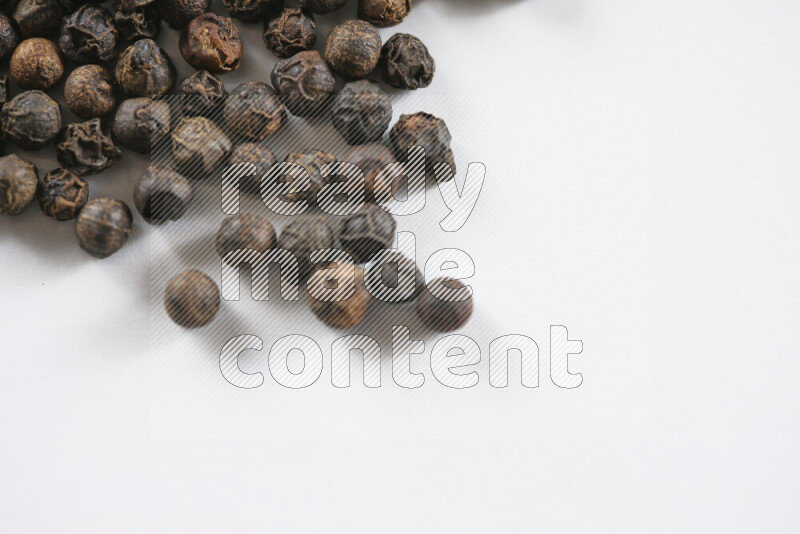 Black pepper beads on white background