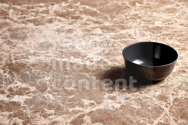 Black Ceramic Bowl on Beige Marble Flooring, 45 degrees