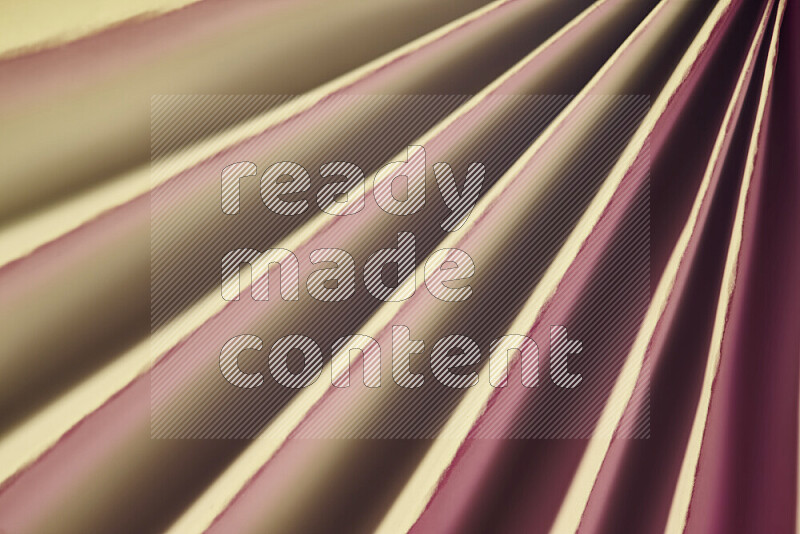An image presenting an abstract paper pattern of lines in red and gold tones