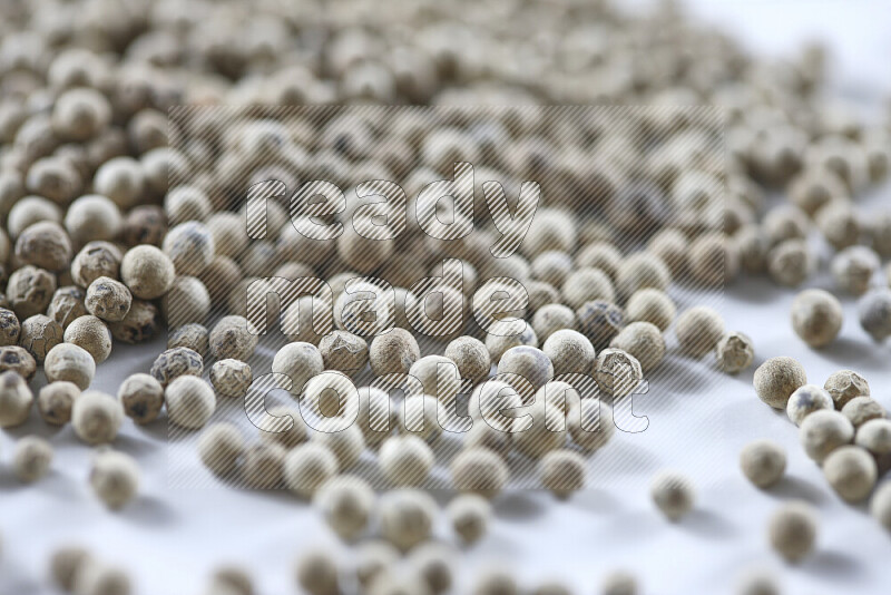 White pepper beads on white background