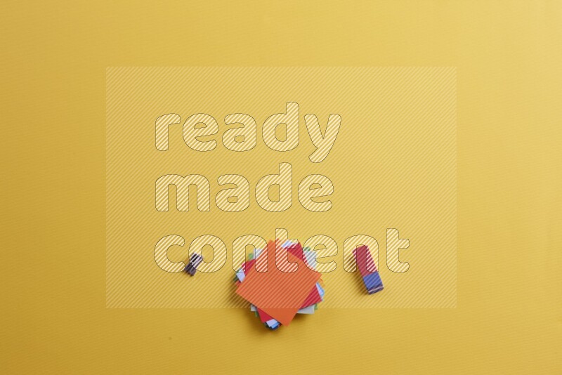 ورق ملاحظات متعدد الألوان مع مستلزمات مدرسية على خلفية صفراء