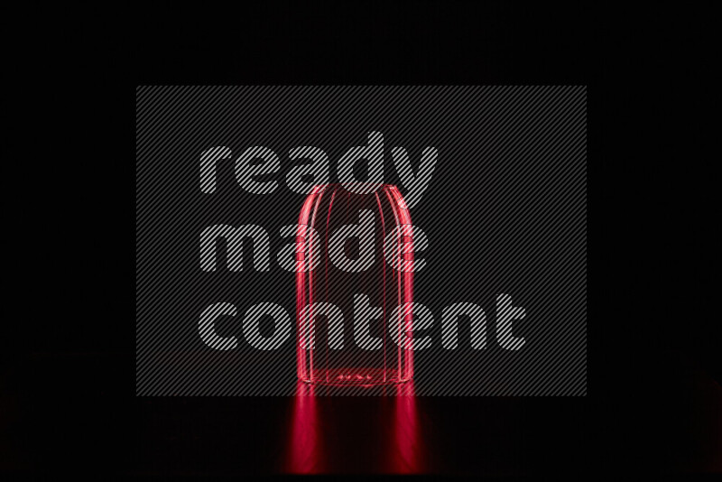 Glassware with rim light in red against black background