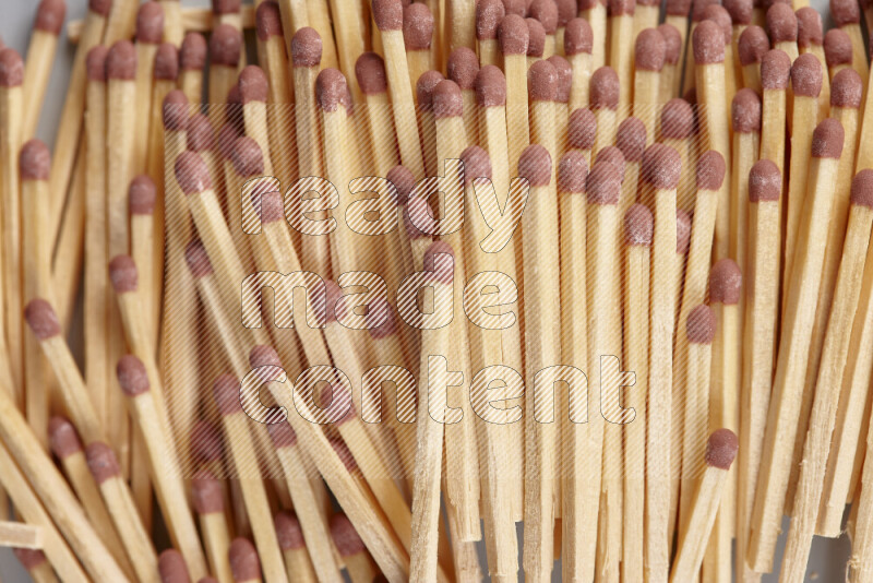 A close-up of a bundle of matches on grey background