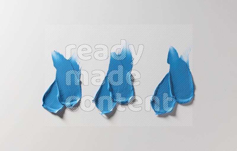 Blue painting knife strokes on white background