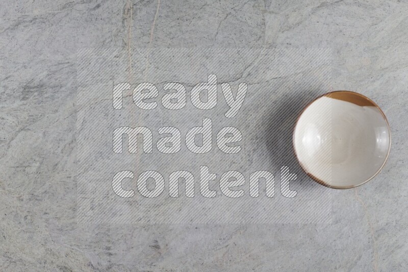 A multicolored pottery plate on grey marble background