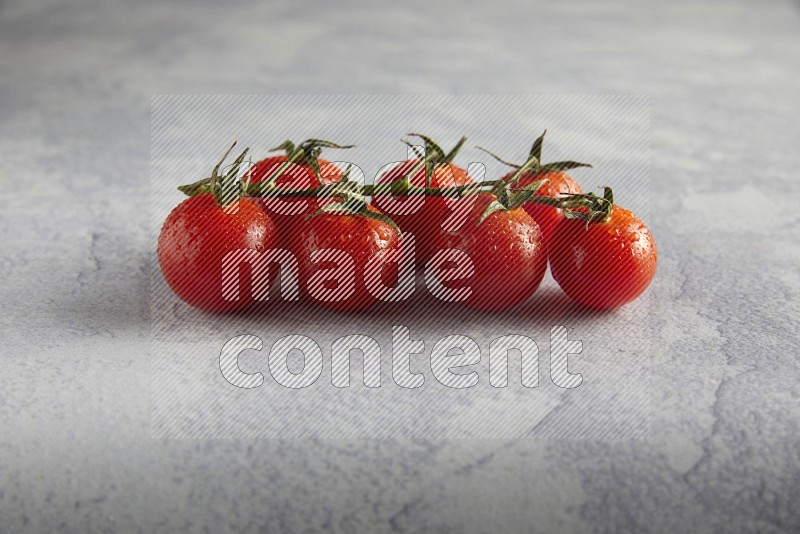 Red cherry tomato vein on a light grey textured background 45 degree