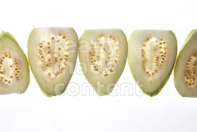 Guava slices on illuminated white background