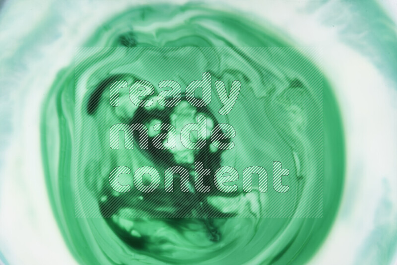 A close-up of abstract swirling patterns in green gradients