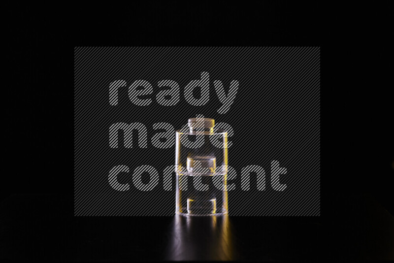 Glassware with rim light in yellow and white against black background