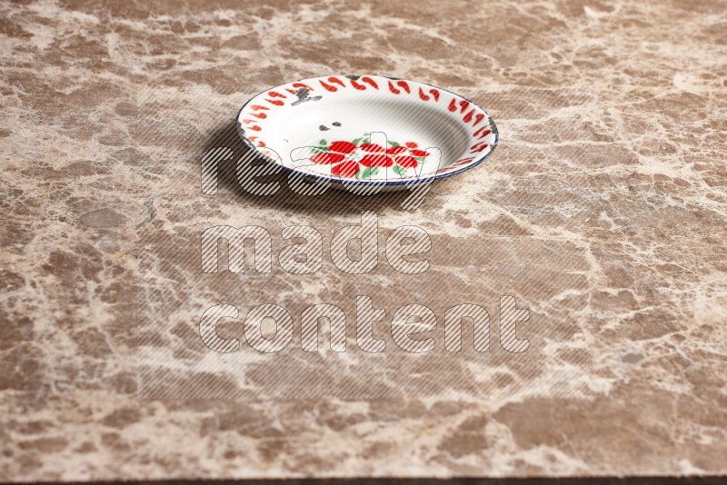 A vintage metal plate on beige marble background