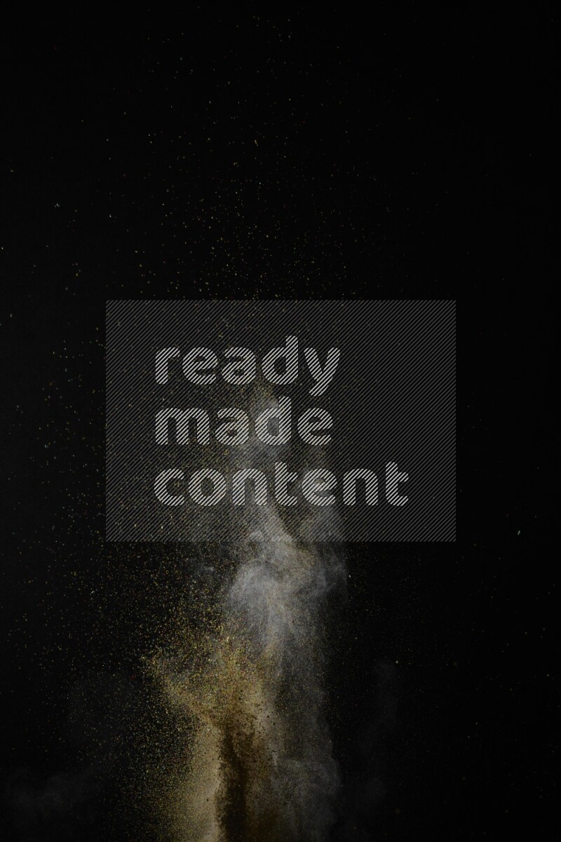 A side view of brown powder explosion on black background