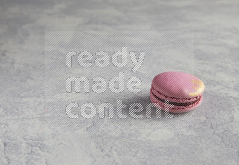 45º Shot of Purple Strawberry macaron on white  marble background