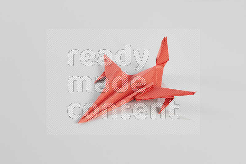 Origami plane on grey background