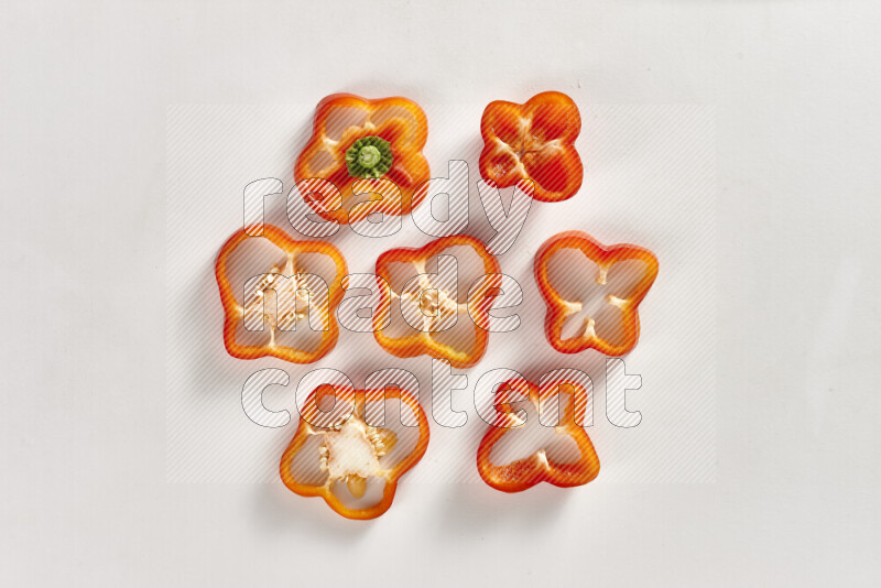 Red bell pepper slices on white background