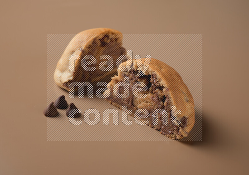 a cookie cut in half on a brown background