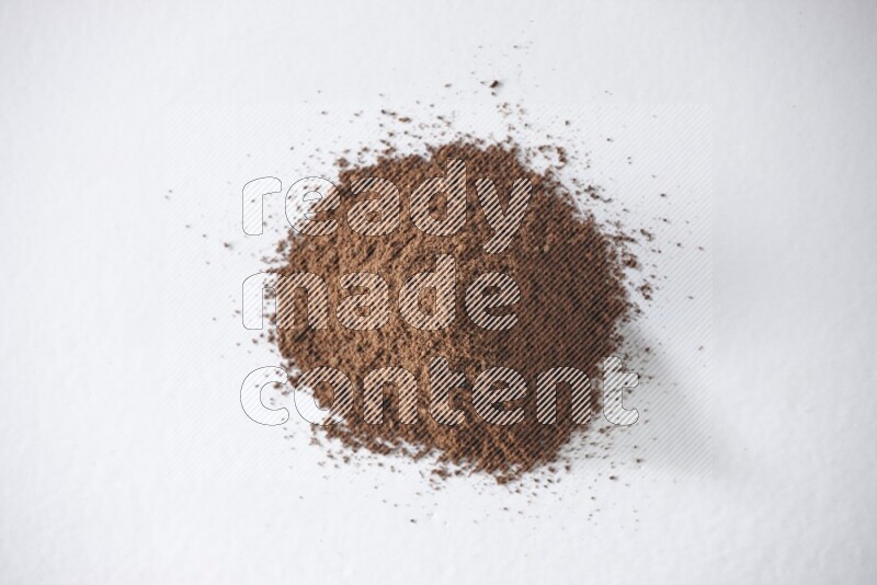A pile of cloves powder on a white flooring