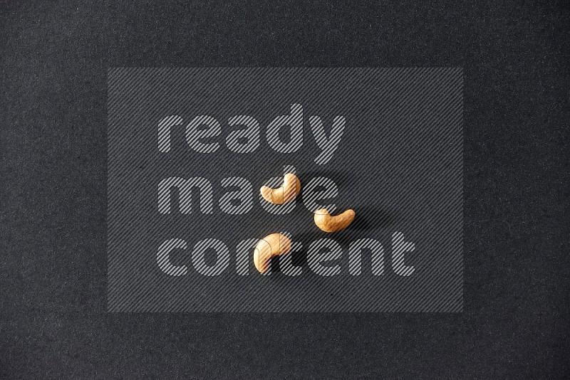 3 cashews on a black background in different angles