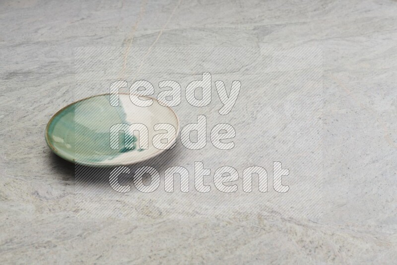 Multicolored Pottery Plate On Grey Marble Flooring