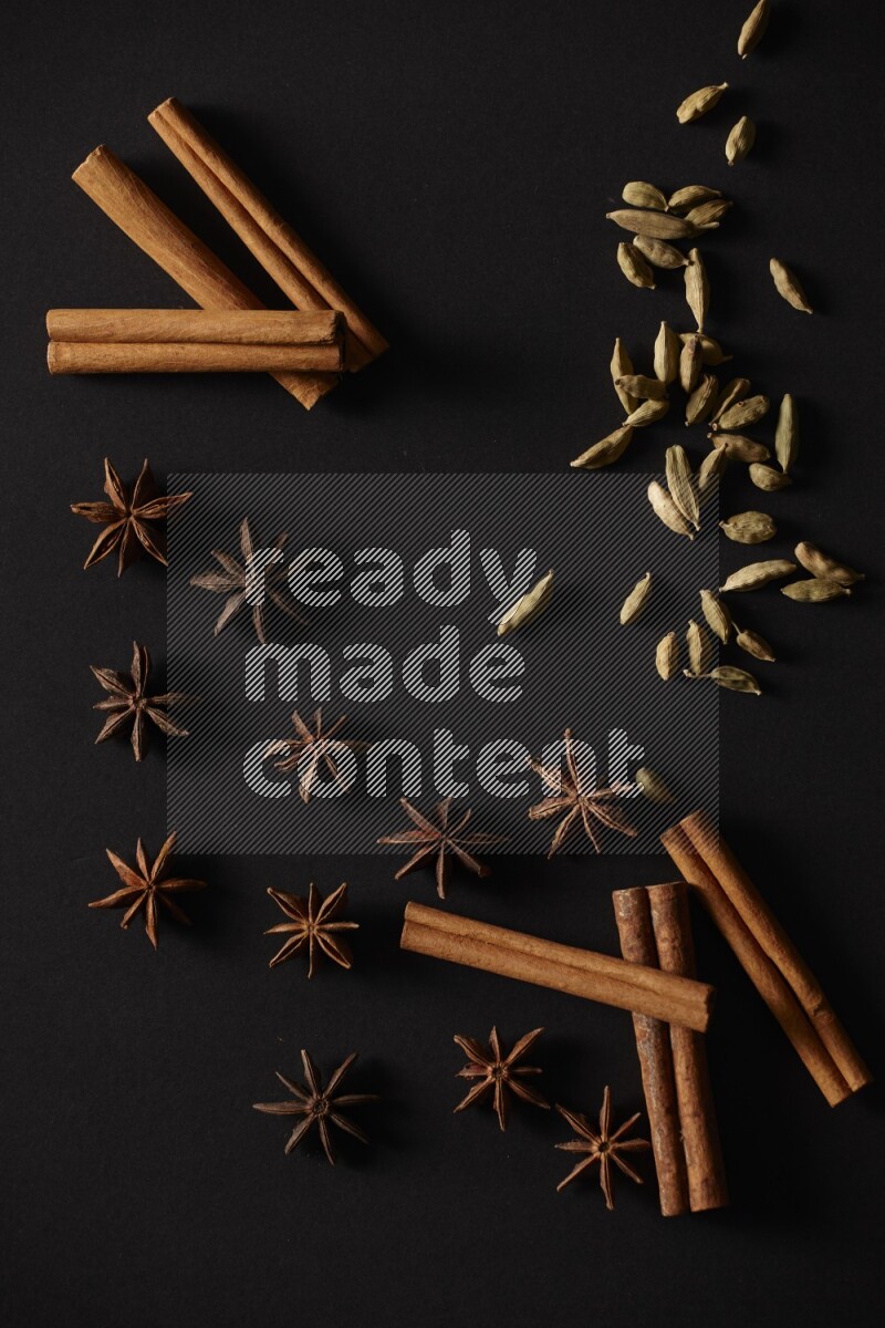 Cinnamon Sticks, Cardamom and star anise on a black background