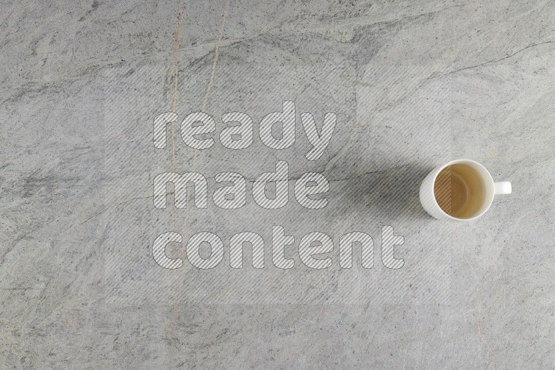 Top View Shot Of A Multicolored Pottery Cup On Grey Marble Flooring