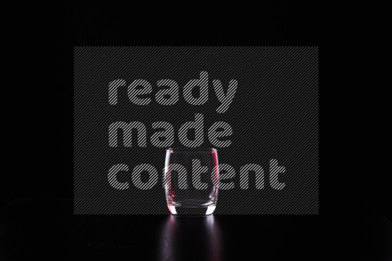 Glassware with rim light in red and white against black background