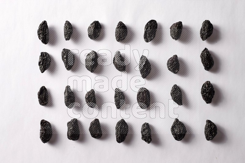 Dried plums on white background