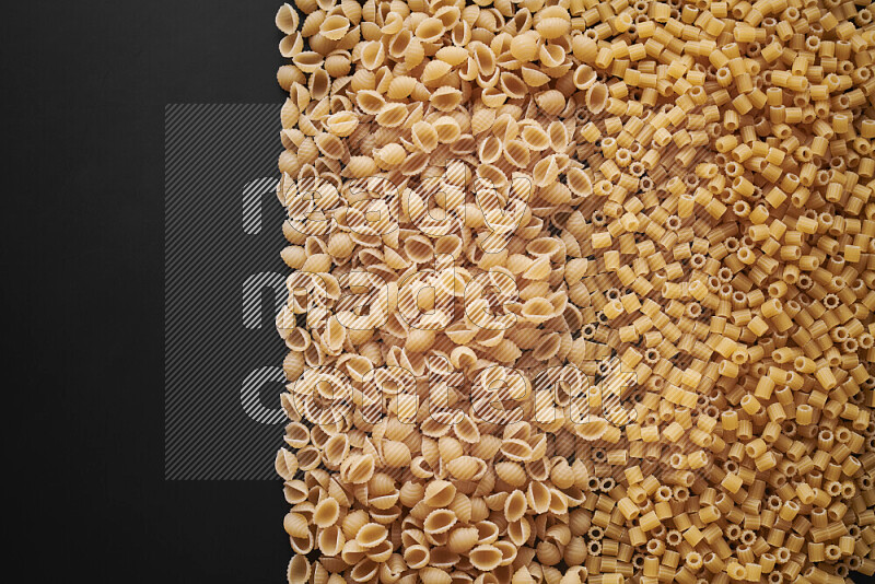 Different pasta types on black background