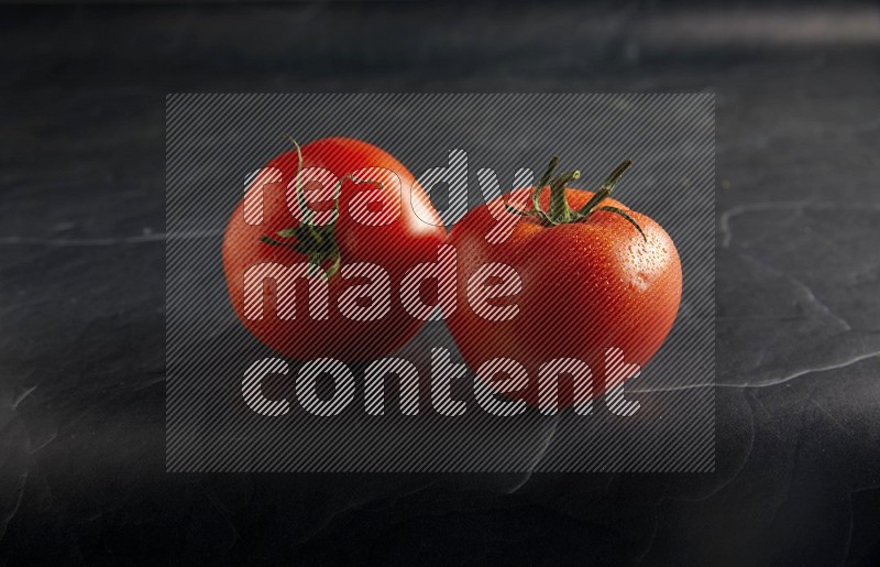 45 degree roma tomato on a textured black slate background